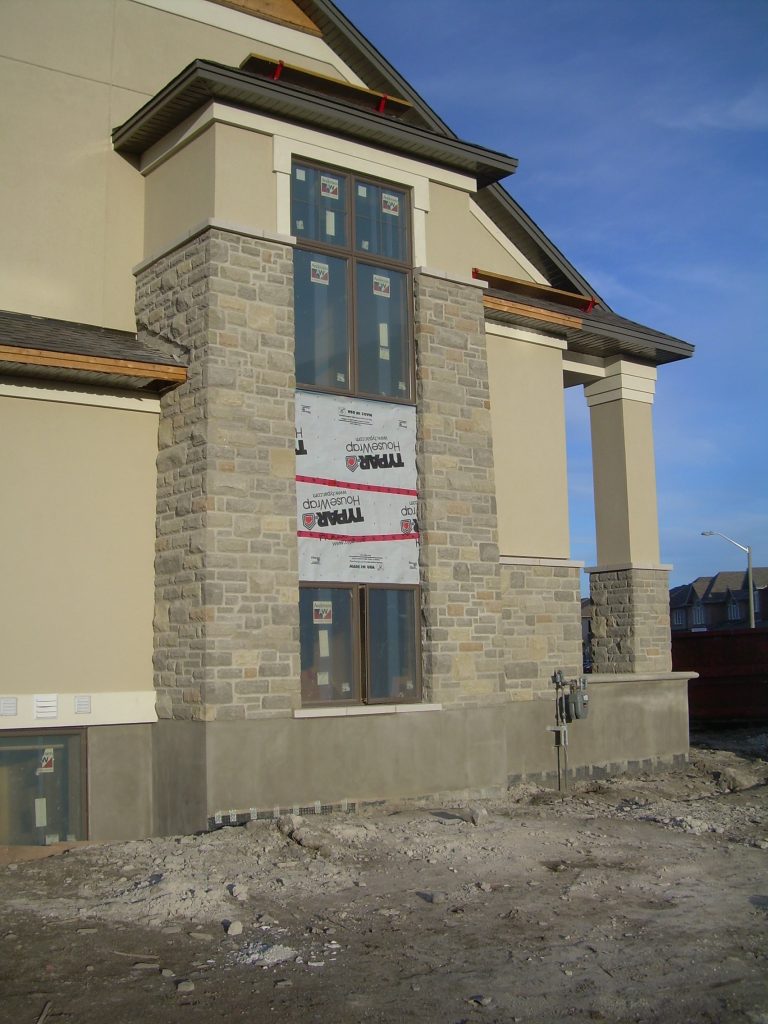 New Stone Home with Nutral Beige Parging and Stone