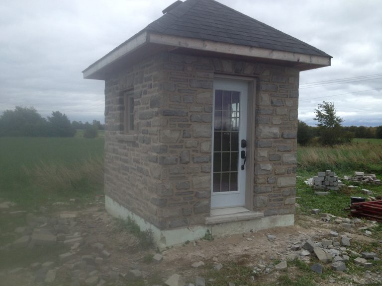 Stone Pump house for future pool alone in field
